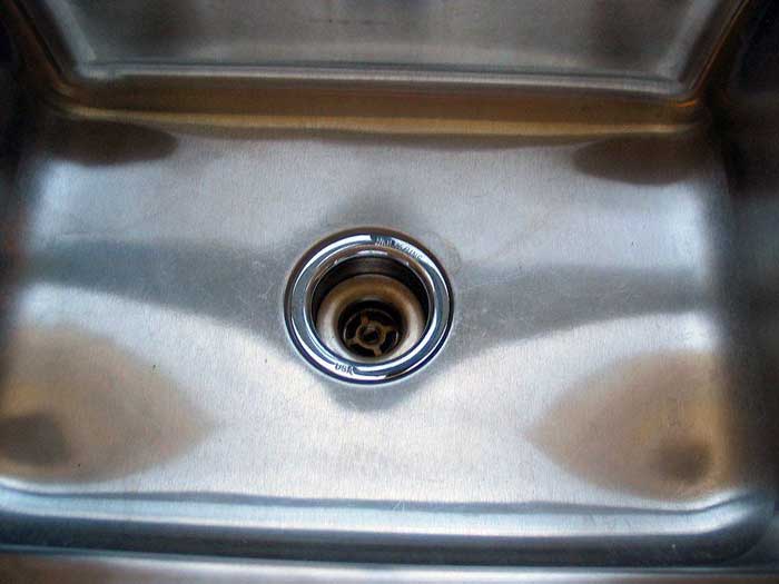 use Ammonia to remove chemical stains from stainless steel sink